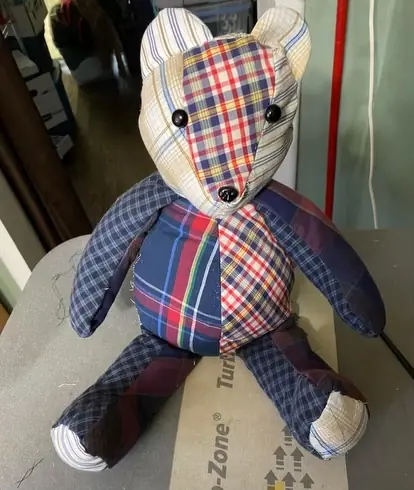 A patchwork memory bear pieced from several plaid shirts