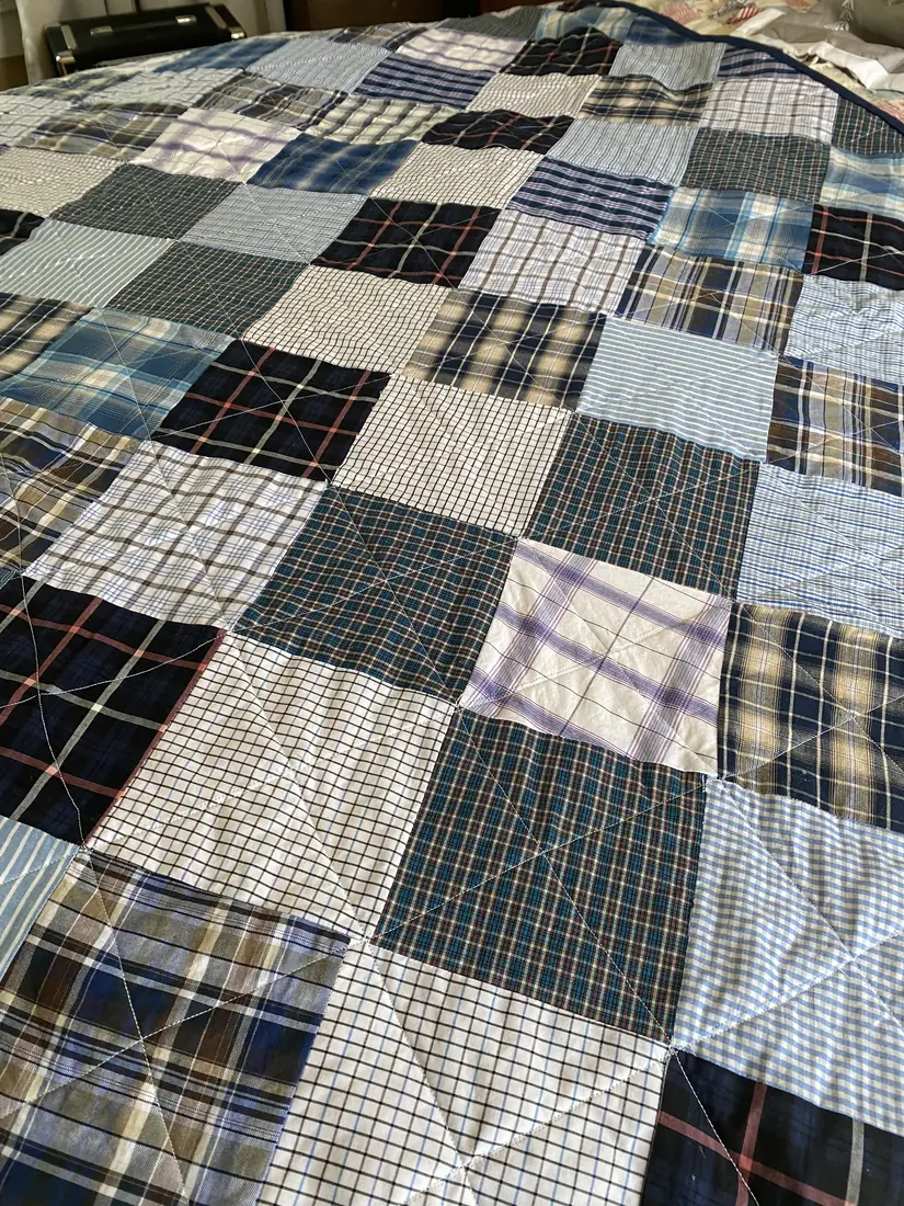 A quilt made from plaid and striped dress shirts