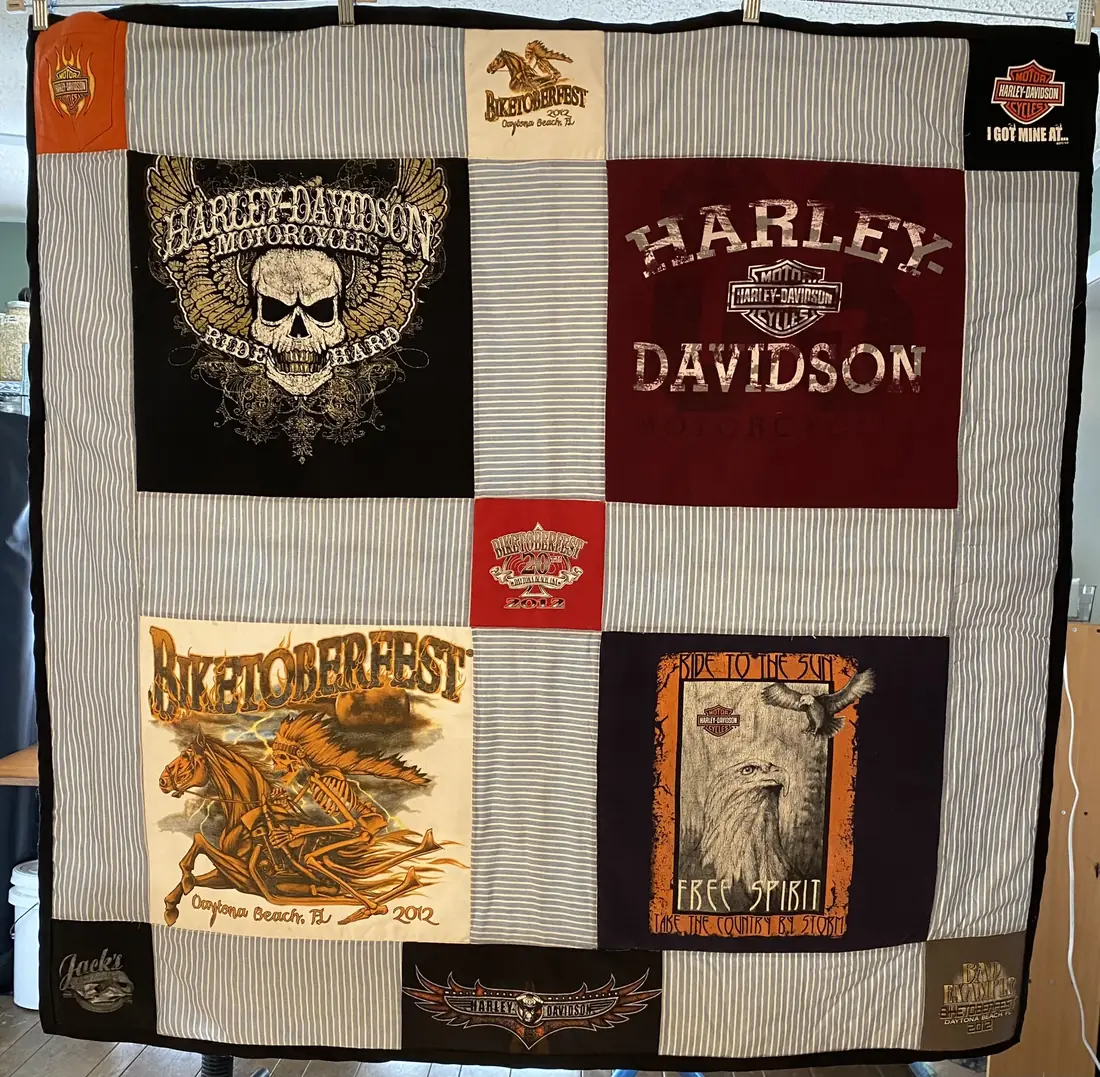 A quilt of bike rally T-shirts in different block sizes