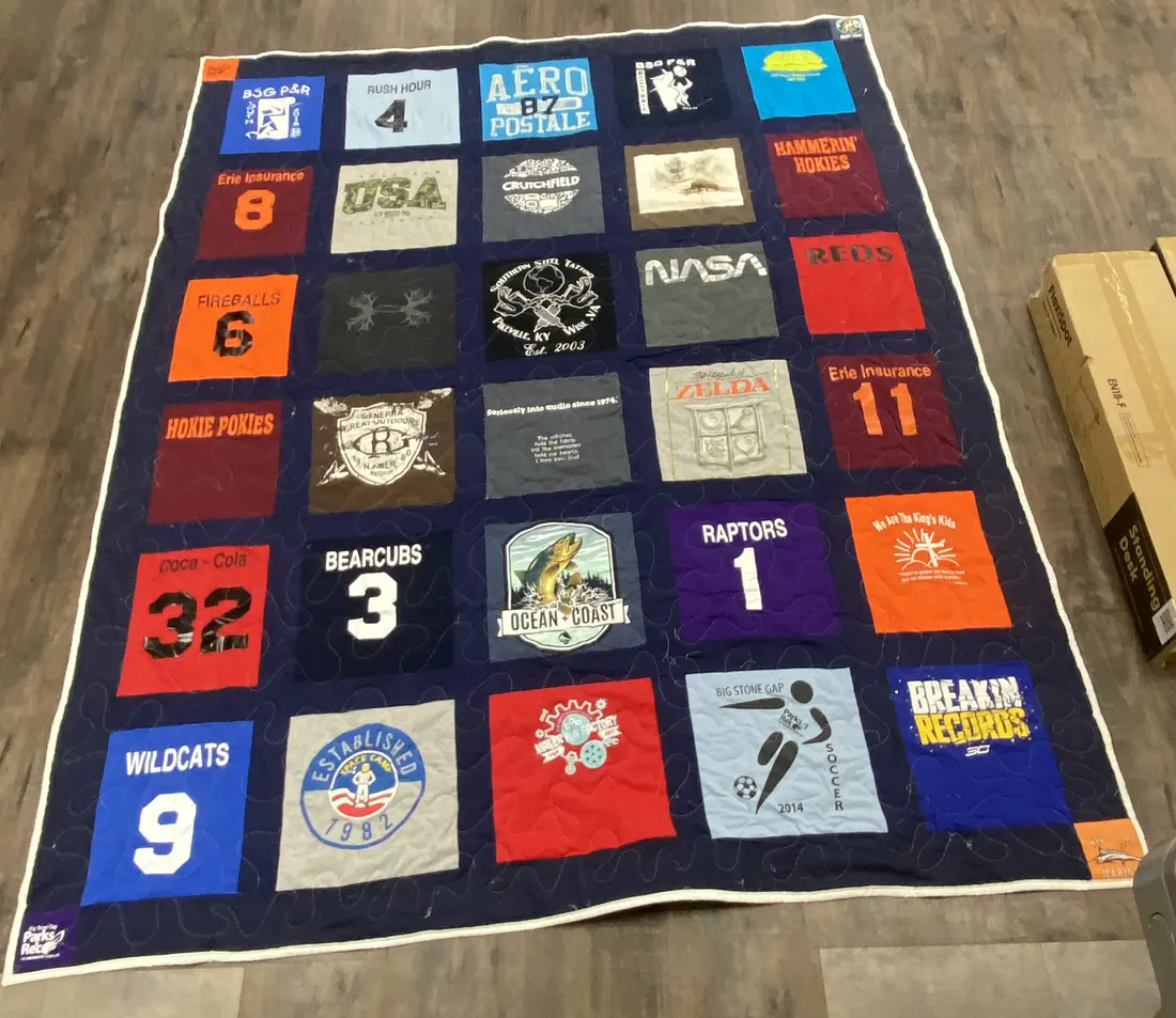 A T-shirt quilt made from school, team, and summer camp shirts
